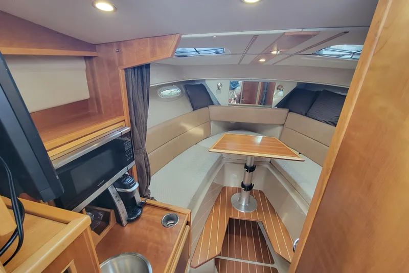  Yacht Photos Pics 2017 Cutwater C28 cabin interior with dining area, microwave, and cozy seating.