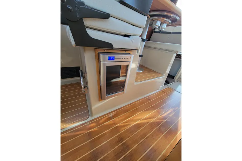  Yacht Photos Pics 2017 Cutwater C28 interior with wooden flooring and built-in mini fridge.