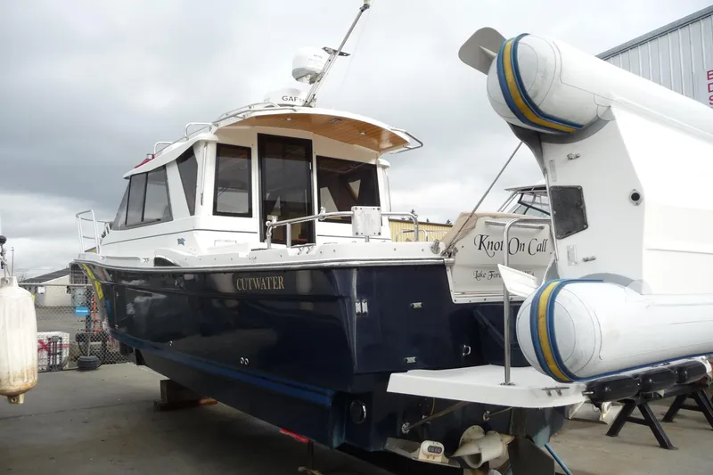  Yacht Photos Pics 2017 Cutwater C28 boat on dry dock, featuring a dark blue hull and white cabin.