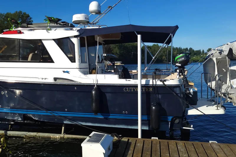  Yacht Photos Pics 2017 Cutwater C28 boat docked on a sunny day with blue water background.