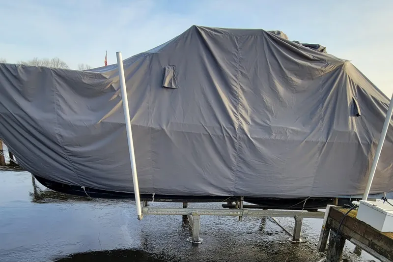  Yacht Photos Pics Covered 2017 Cutwater C28 boat on a lift, wrapped in a protective tarp.