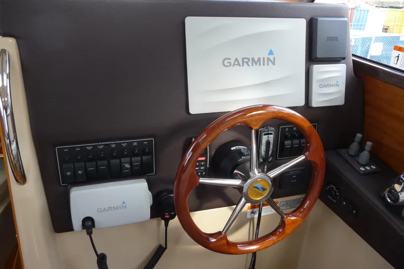  Yacht Photos Pics 2017 Cutwater C28 helm with Garmin navigation and wooden steering wheel.