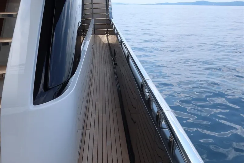 Ruzarija Yacht Photos Pics Side deck view of 2020 Riva 100' Corsaro yacht on calm sea.