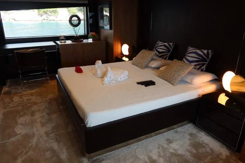 Ruzarija Yacht Photos Pics Luxurious bedroom interior on 2020 Riva 100' Corsaro yacht with elegant decor and scenic view.