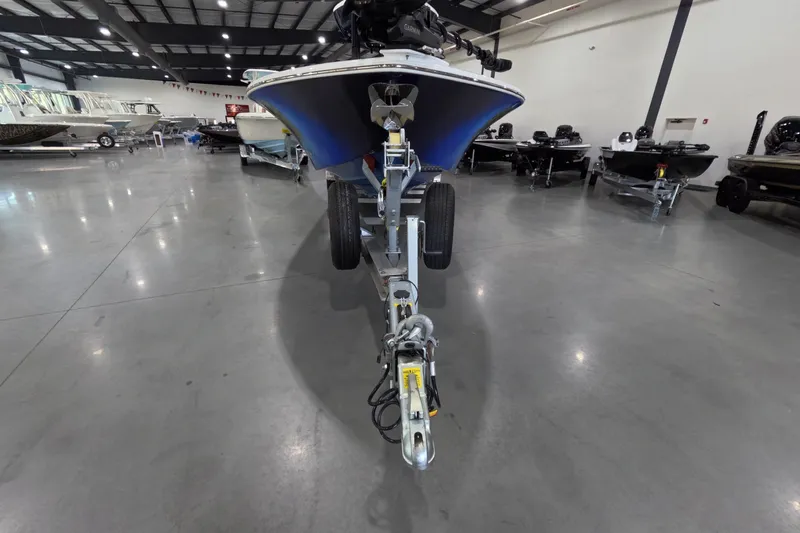  Yacht Photos Pics 2024 Tidewater boat on trailer in showroom, surrounded by other boats.