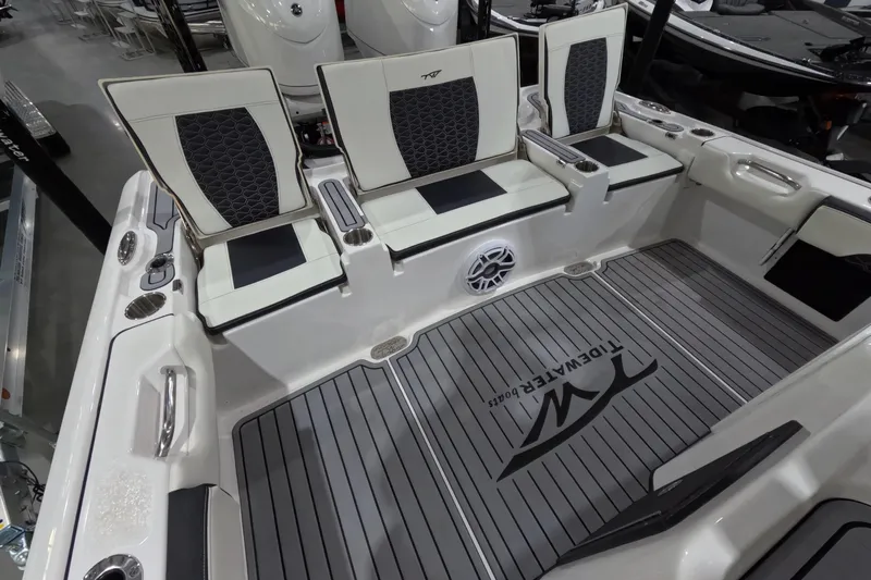  Yacht Photos Pics 2024 Tidewater boat interior with cushioned seating and branded flooring.