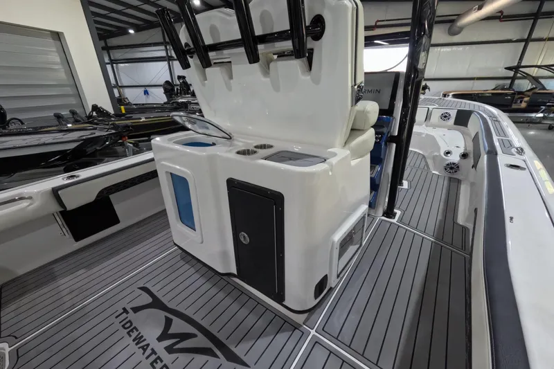  Yacht Photos Pics 2024 Tidewater boat interior with sleek seating, rod holders, and modern design in a showroom.