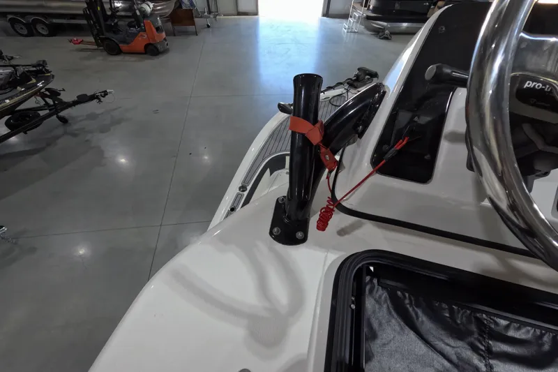  Yacht Photos Pics 2024 Tidewater boat interior with steering wheel and control panel in a showroom.