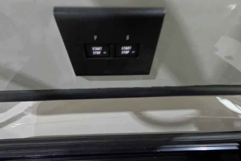  Yacht Photos Pics 2024 Tidewater start/stop button panel on a sleek surface.