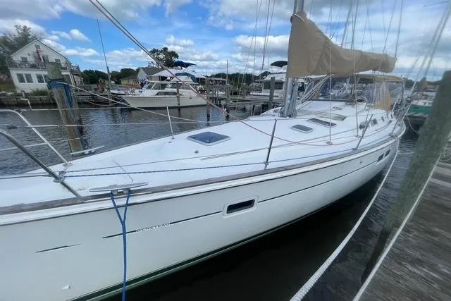 At Last Yacht Photos Pics 2004 Beneteau 423 sailboat docked at marina under blue sky.