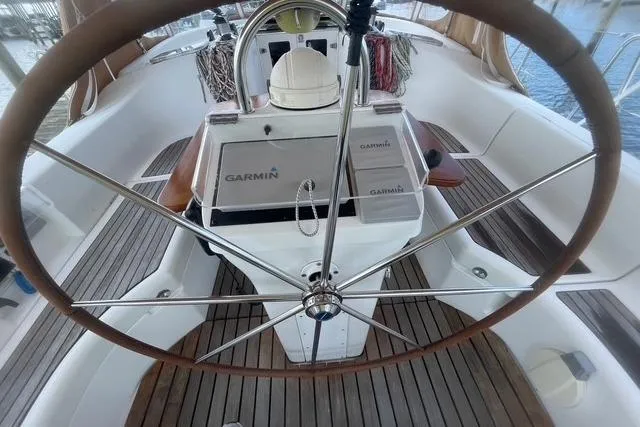 At Last Yacht Photos Pics 2004 Beneteau 423 yacht cockpit with Garmin navigation system and wooden deck.