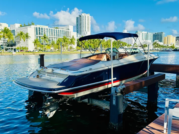  Yacht Photos Pics 2015 Chris-Craft Launch 32 boat docked in a sunny marina with cityscape background.