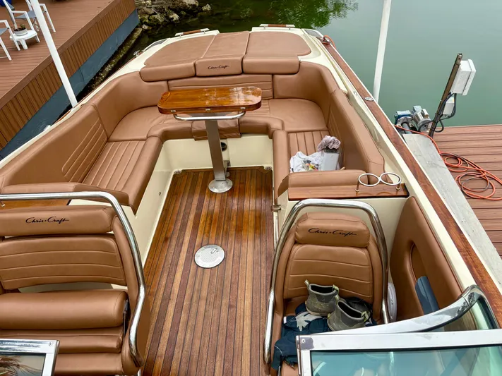  Yacht Photos Pics 2015 Chris-Craft Launch 32 boat interior with brown leather seating and wooden deck.