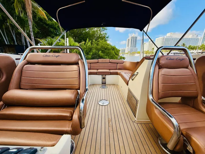  Yacht Photos Pics 2015 Chris-Craft Launch 32 interior with brown leather seats and wooden deck.