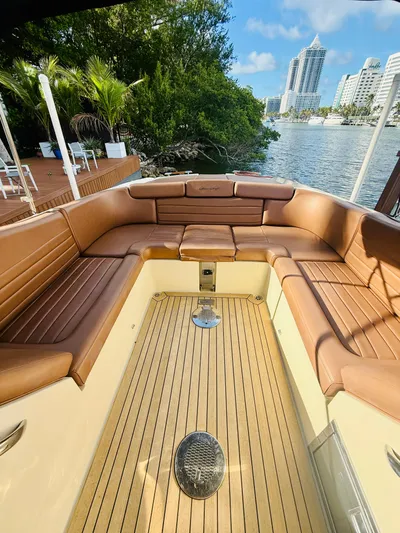  Yacht Photos Pics 2015 Chris-Craft Launch 32 boat interior with brown leather seating and wooden deck.
