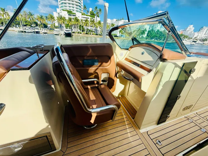  Yacht Photos Pics 2015 Chris-Craft Launch 32 interior with luxurious seating and waterfront view.
