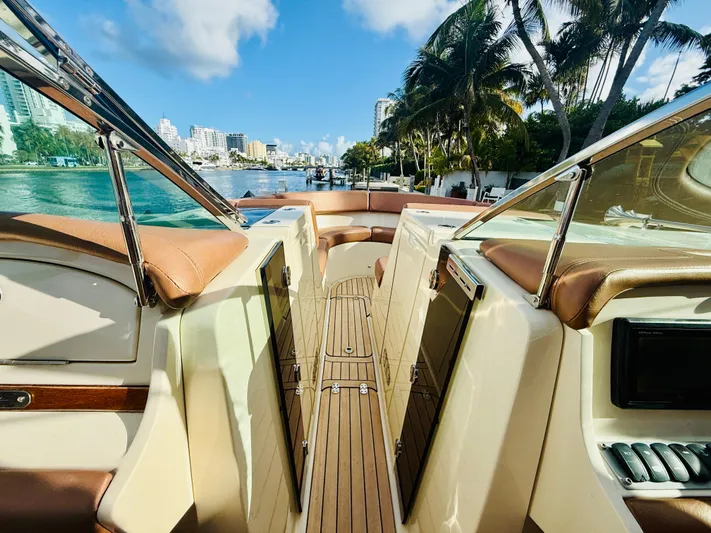  Yacht Photos Pics 2015 Chris-Craft Launch 32 boat interior with luxurious seating and scenic waterfront view.