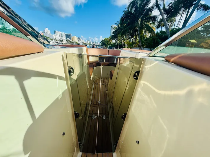  Yacht Photos Pics 2015 Chris-Craft Launch 32 boat interior with cityscape and palm trees in background.