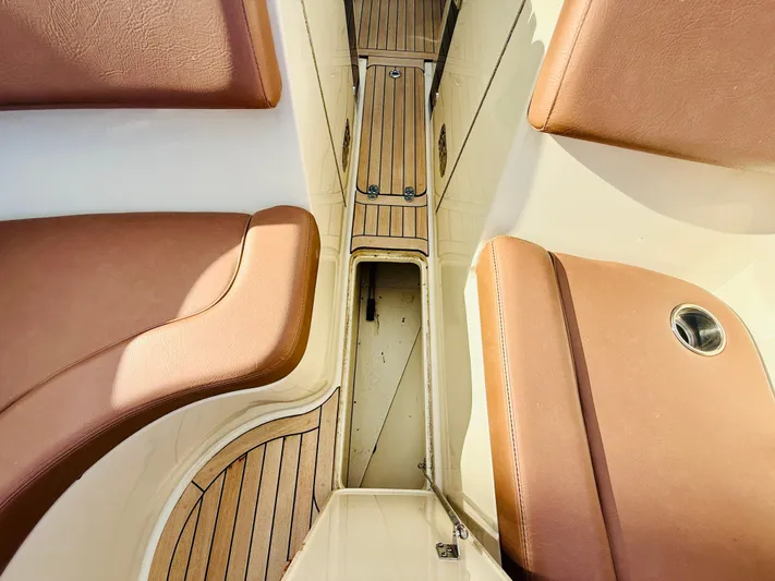  Yacht Photos Pics 2015 Chris-Craft Launch 32 interior with tan leather seats and wooden flooring.