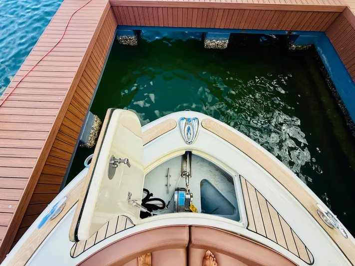 Yacht Photos Pics 2015 Chris-Craft Launch 32 docked, showing open storage compartment and teak deck.