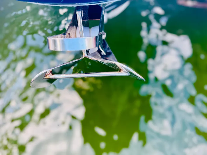  Yacht Photos Pics Close-up of a 2015 Chris-Craft Launch 32 boat anchor over green water.