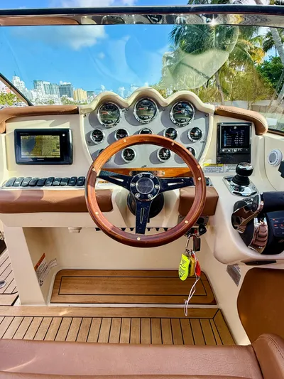  Yacht Photos Pics 2015 Chris-Craft Launch 32 dashboard with wooden steering wheel and modern controls.
