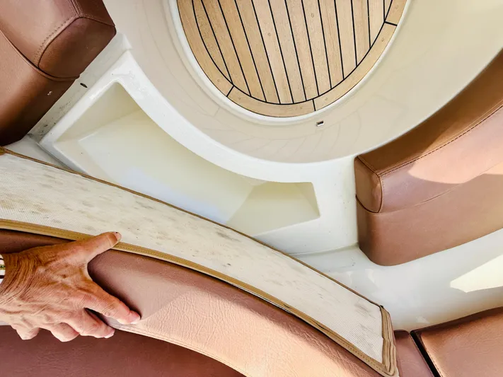  Yacht Photos Pics 2015 Chris-Craft Launch 32 interior with brown leather seating and wooden flooring.