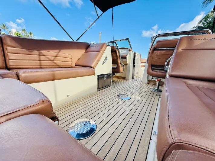  Yacht Photos Pics 2015 Chris-Craft Launch 32 interior with brown leather seats and teak flooring under blue sky.