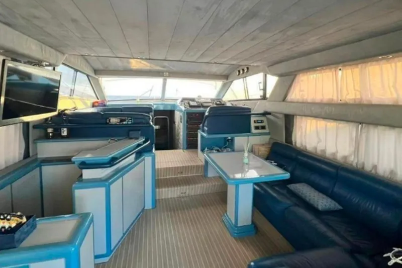  Yacht Photos Pics Luxurious interior of 1991 Dalla Pieta 52 Asterion yacht with blue seating and modern amenities.