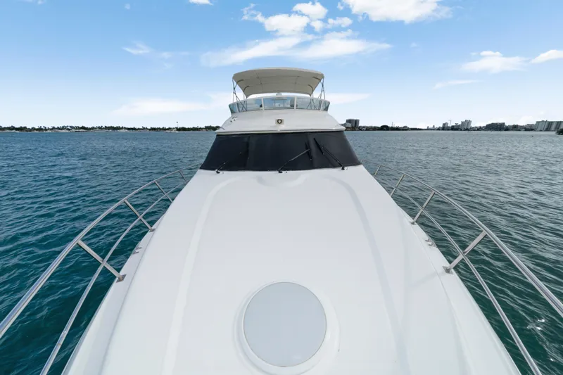 Mimosa Yacht Photos Pics 2001 Cruisers Yachts 5000 Sedan Sport on open water, clear sky background.