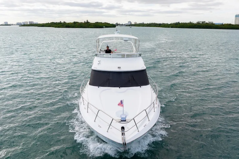 Mimosa Yacht Photos Pics 2001 Cruisers Yachts 5000 Sedan Sport cruising on open water, front view.