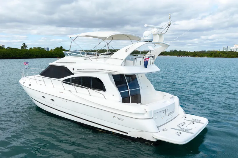 Mimosa Yacht Photos Pics 2001 Cruisers Yachts 5000 Sedan Sport on serene water, showcasing elegant design.