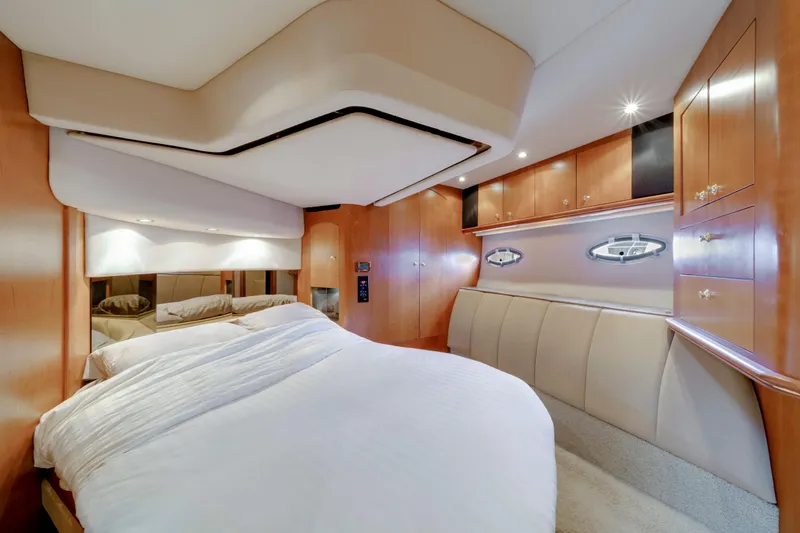 Mimosa Yacht Photos Pics Luxurious bedroom interior of 2001 Cruisers Yachts 5000 Sedan Sport with wood cabinetry.
