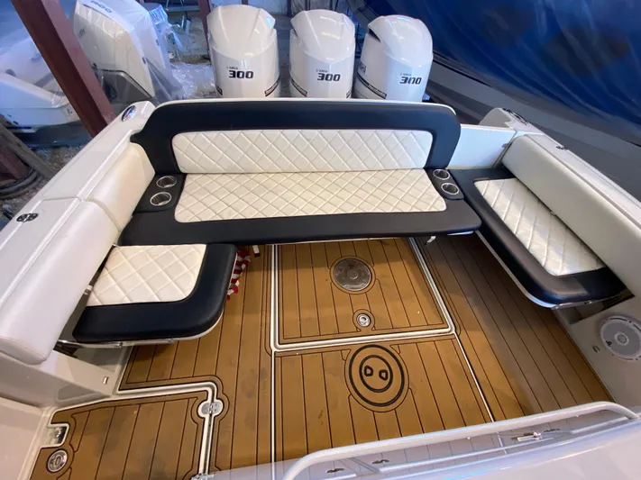 Apres Sea Yacht Photos Pics 2016 Chris-Craft Catalina 34 boat interior with cushioned seating and teak flooring.