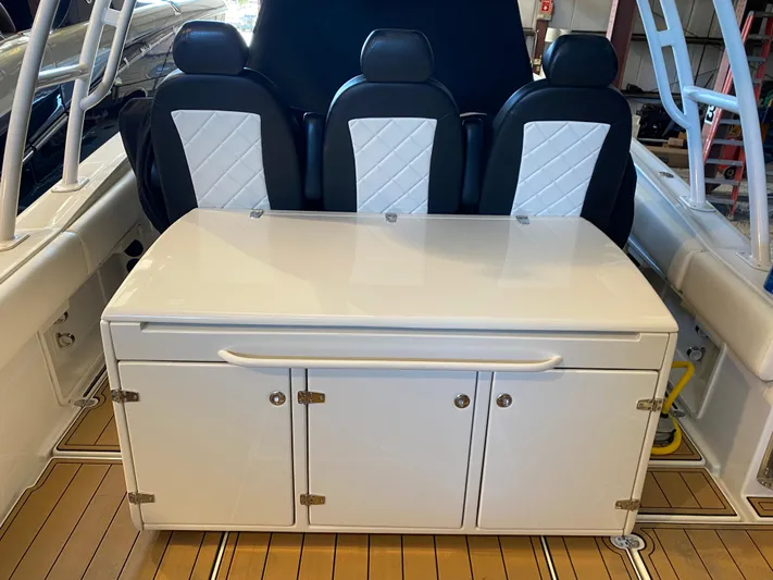 Apres Sea Yacht Photos Pics 2016 Chris-Craft Catalina 34 interior with seating and storage cabinet.