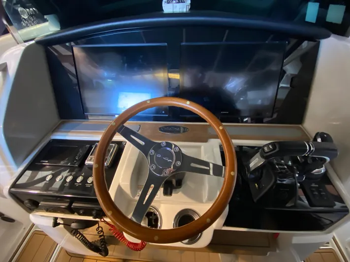 Apres Sea Yacht Photos Pics Helm of 2016 Chris-Craft Catalina 34 with wooden steering wheel and modern controls.