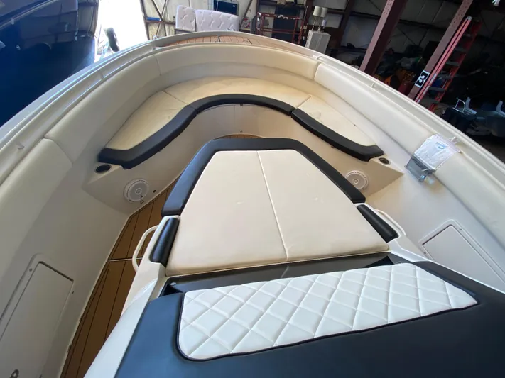 Apres Sea Yacht Photos Pics 2016 Chris-Craft Catalina 34 boat interior with cushioned seating and wood flooring.