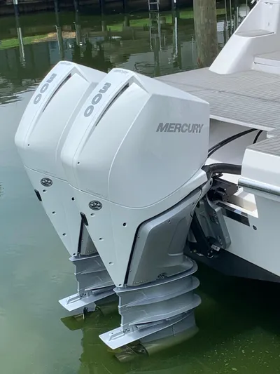  Yacht Photos Pics Twin Mercury outboard motors on a 2022 Evolve 360HT boat, docked in calm water.