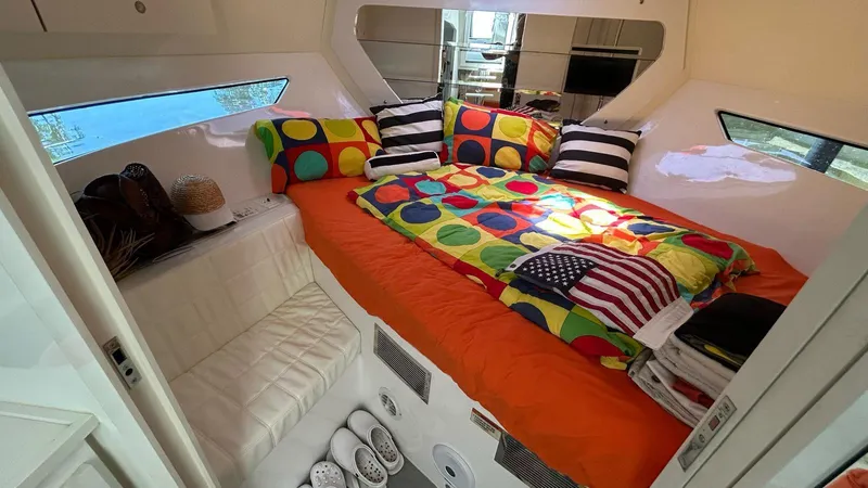  Yacht Photos Pics Cozy cabin interior of 2022 Evolve 360HT with colorful bedding and modern decor.