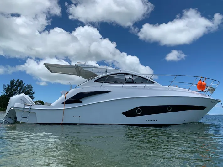  Yacht Photos Pics 2022 Evolve 360HT yacht on calm water under a partly cloudy sky.