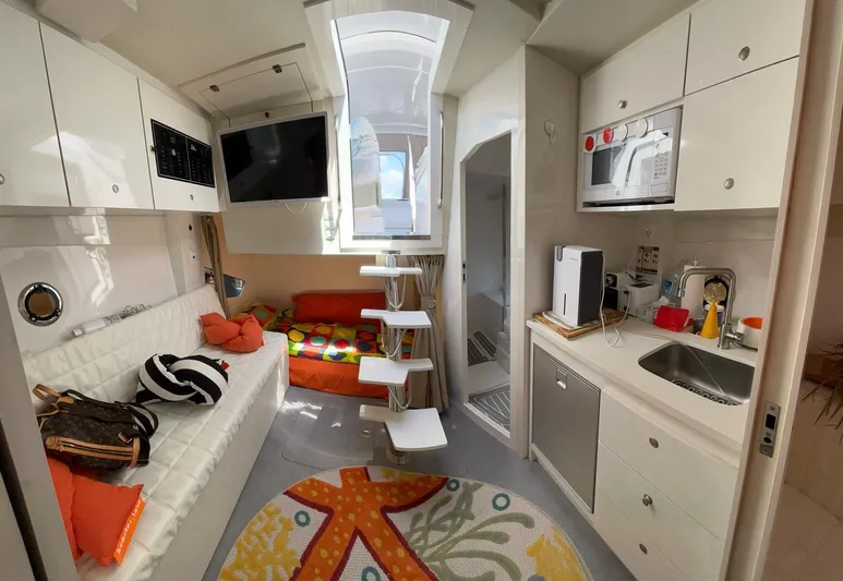  Yacht Photos Pics Modern interior of 2022 Evolve 360HT camper with kitchen, seating, and colorful decor.