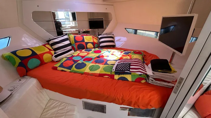  Yacht Photos Pics Luxurious 2022 Evolve 360HT yacht bedroom with colorful bedding and modern decor.
