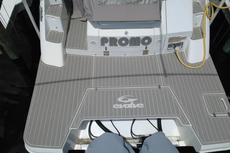  Yacht Photos Pics 2022 Evolve 360HT boat deck with gray non-slip surface and logo.