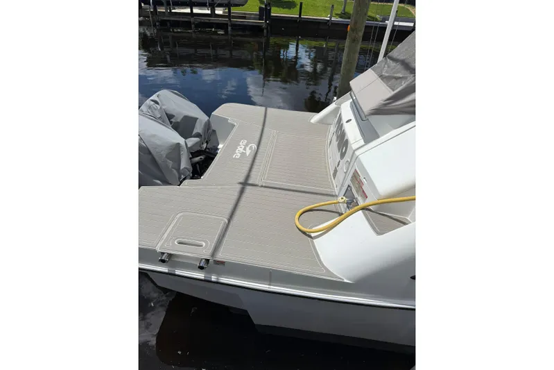  Yacht Photos Pics 2022 Evolve 360HT boat stern with covered engines and dockside view.