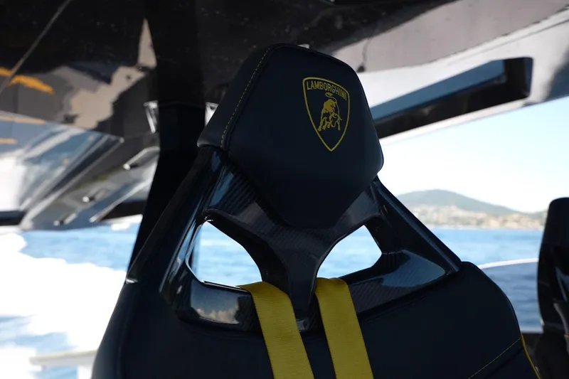  Yacht Photos Pics Luxury seat on 2023 Tecnomar Lamborghini 63 yacht, featuring iconic logo and sleek design.