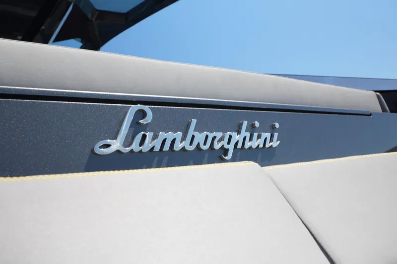  Yacht Photos Pics Close-up of 2023 Tecnomar Lamborghini 63 yacht logo against blue sky.