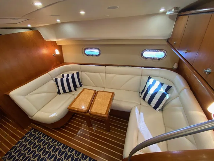 Kostas More Yacht Photos Pics Interior of 2009 Tiara Yachts 4300 Sovran with leather sofa and wooden table.