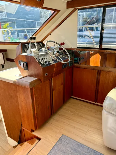 Journey's End Yacht Photos Pics Helm of a 1989 Californian 48MY yacht with wooden interior.