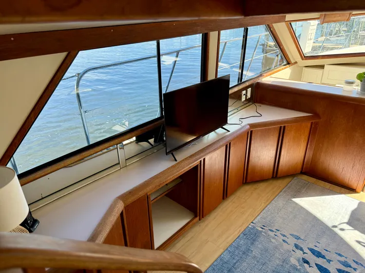 Journey's End Yacht Photos Pics Interior of a 1989 Californian 48MY yacht with wooden cabinetry and TV.
