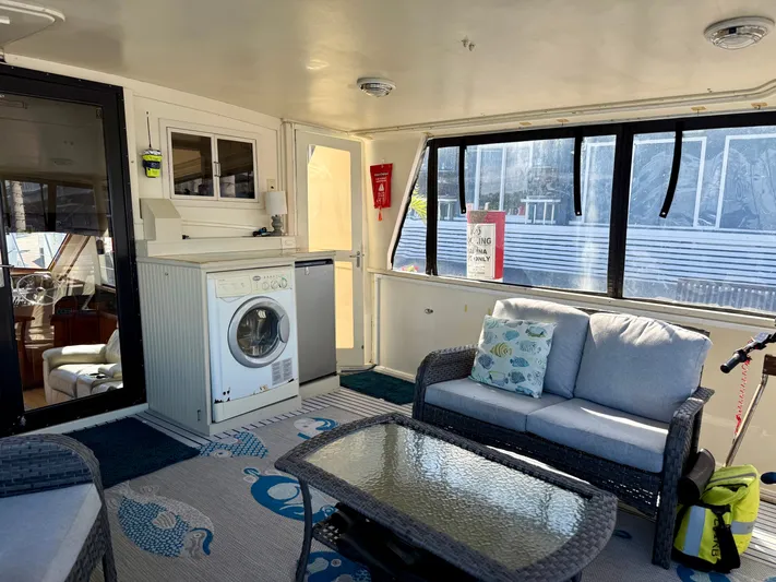 Journey's End Yacht Photos Pics Interior of a 1989 Californian 48MY yacht with washing machine and sofa.